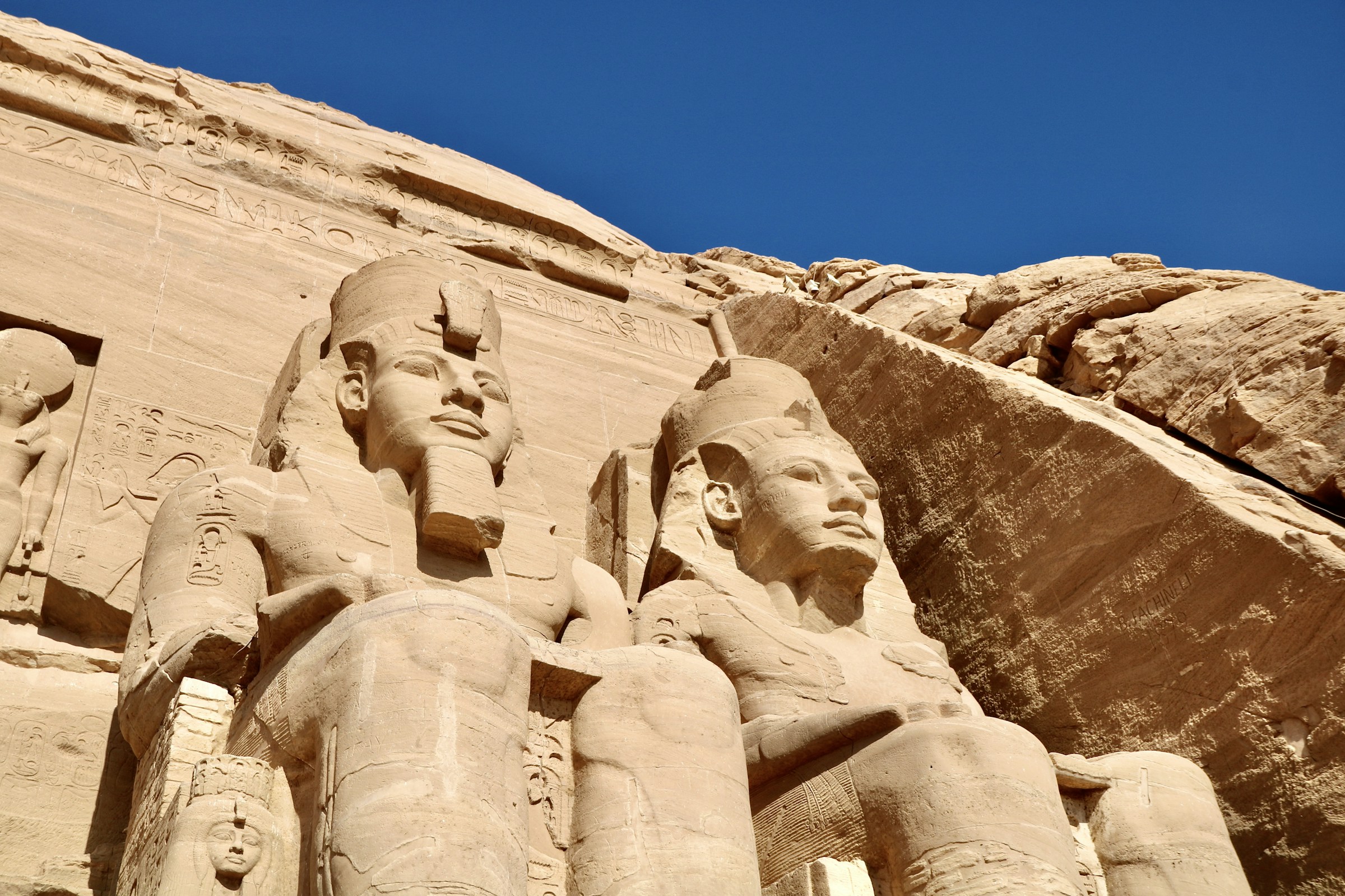 The colossal seated figures cut into the rock face of the great temple at Abu Simbel
