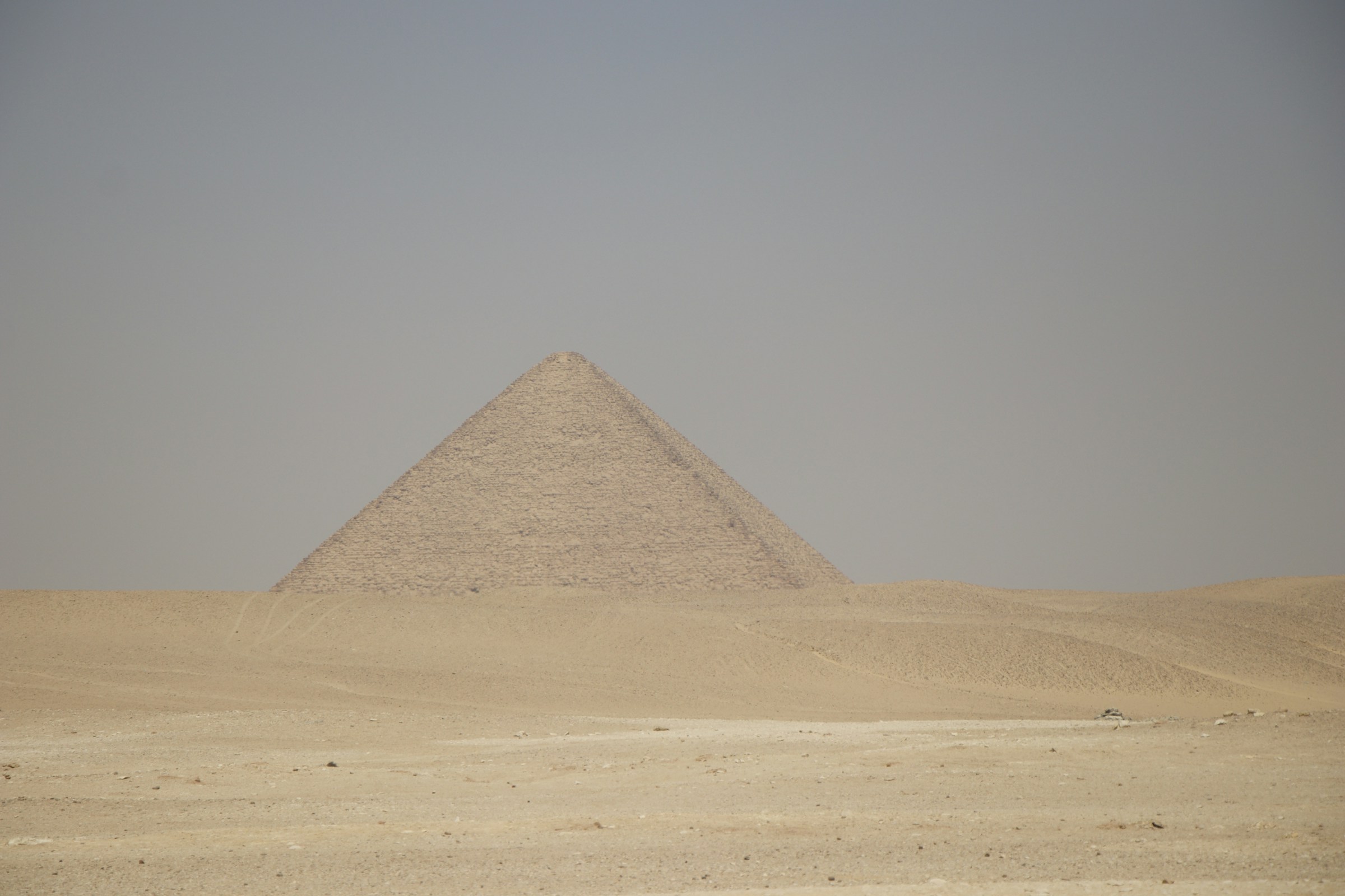 A smooth-sided pyramid standing alone in the desert at Dahshur